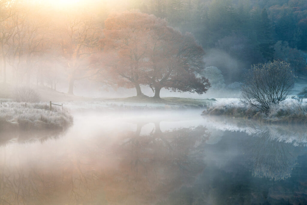 Misty lakeside sunrise representing the quiet, remote locations campervans can access.
