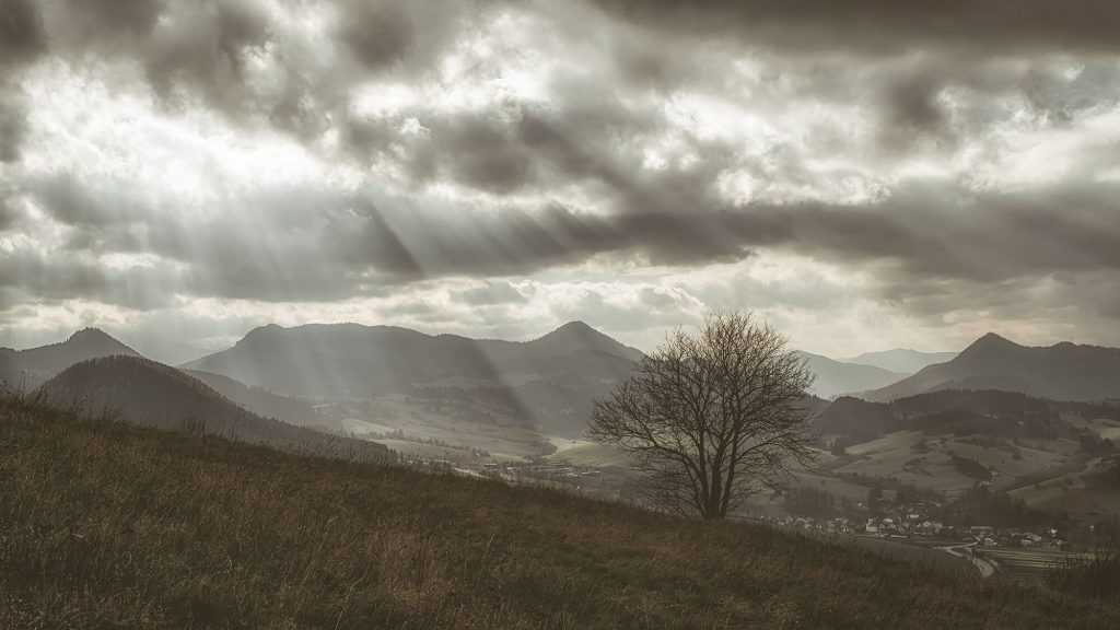 Moody mountain landscape in the Peak District with dramatic clouds and distant hills
