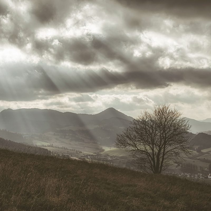 Moody mountain landscape in the Peak District with dramatic clouds and distant hills