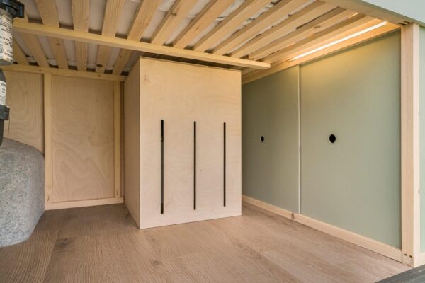 Campervan rear wardrobe or storage unit with slatted timber ceiling and clean-lined design.
