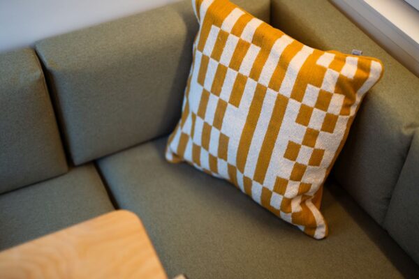 Upholstered campervan seating with patterned cushion inside a Bhode campervan conversion