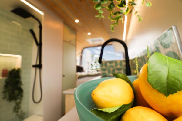 Campervan kitchen detail with oak worktops and modern interior styling