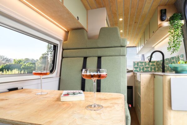Campervan dining table with countryside views and contemporary interior design