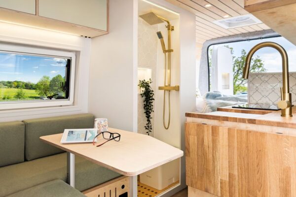 Campervan lounge seating and shower room in a handcrafted Bhode Vans conversion