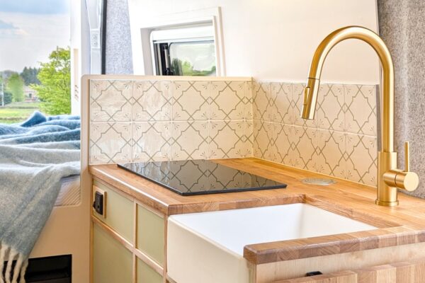 Campervan kitchen with induction hob, Belfast sink and solid oak worktops