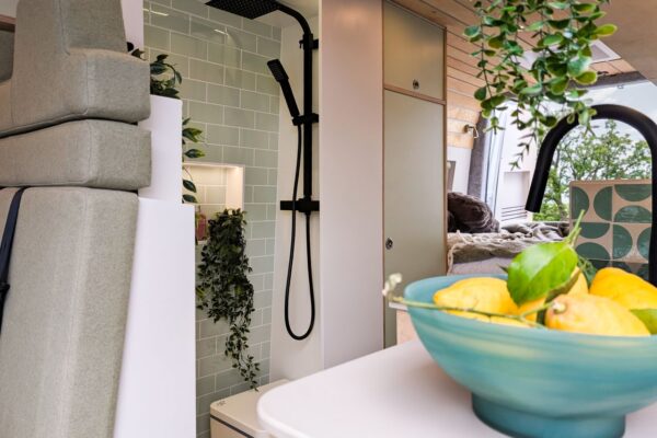 Campervan shower room and kitchen area with oak worktops and contemporary styling